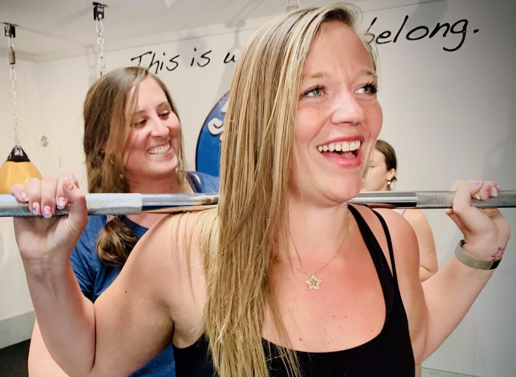 Smiling women at Strong Martha working out.